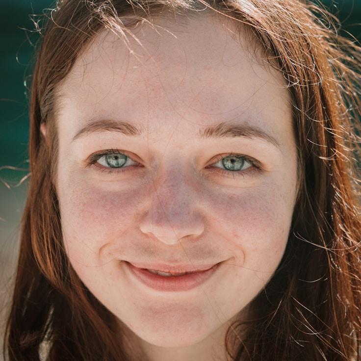 Avery Singh, Lead Design Curator at DawnQuartzMeadow, reviewing corporate floral arrangements